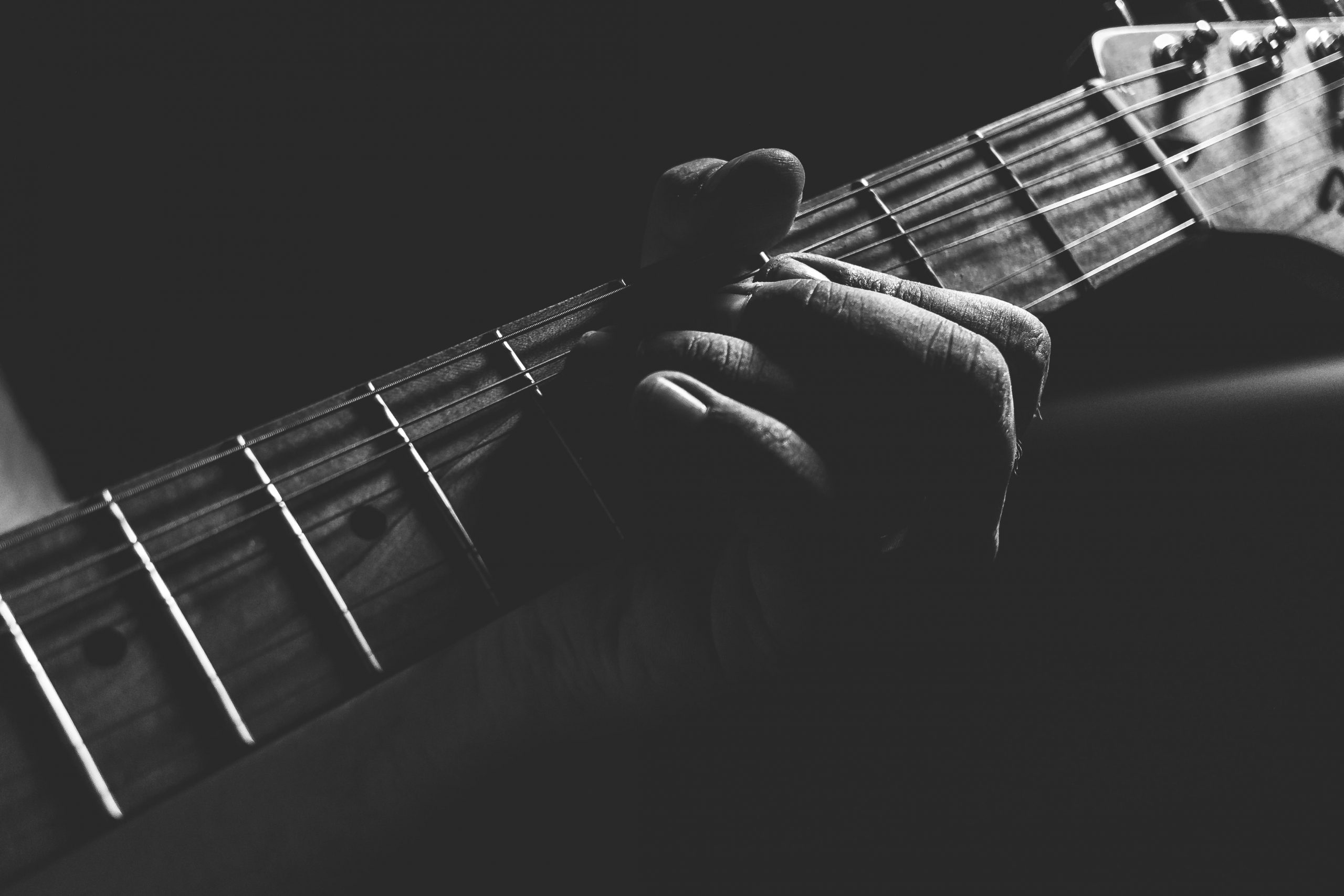 Grayscale closeup of guitar strings